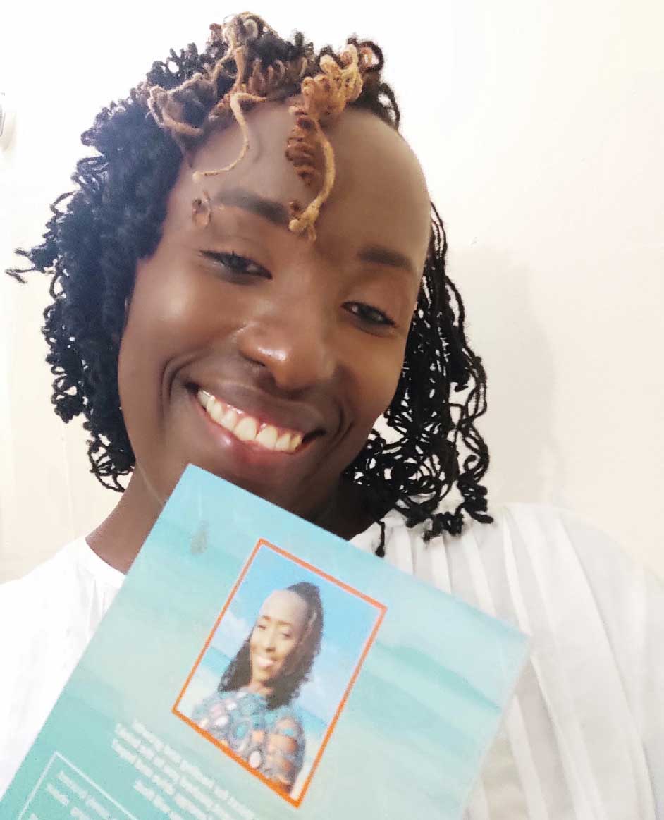 A smiling Emlynn Francis showing off her book.