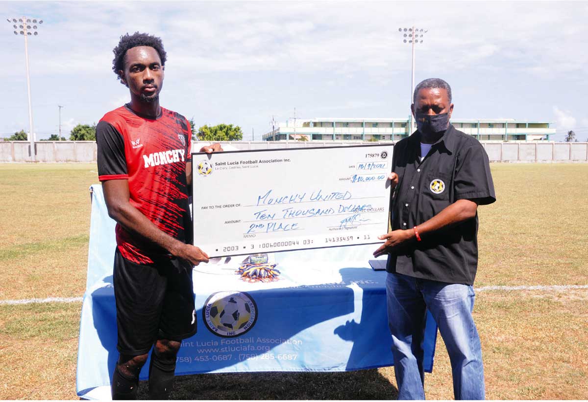 SLFA’s Lyndon Cooper presents cheque to runners-up Monchy FC Skipper Otev Lawrence.