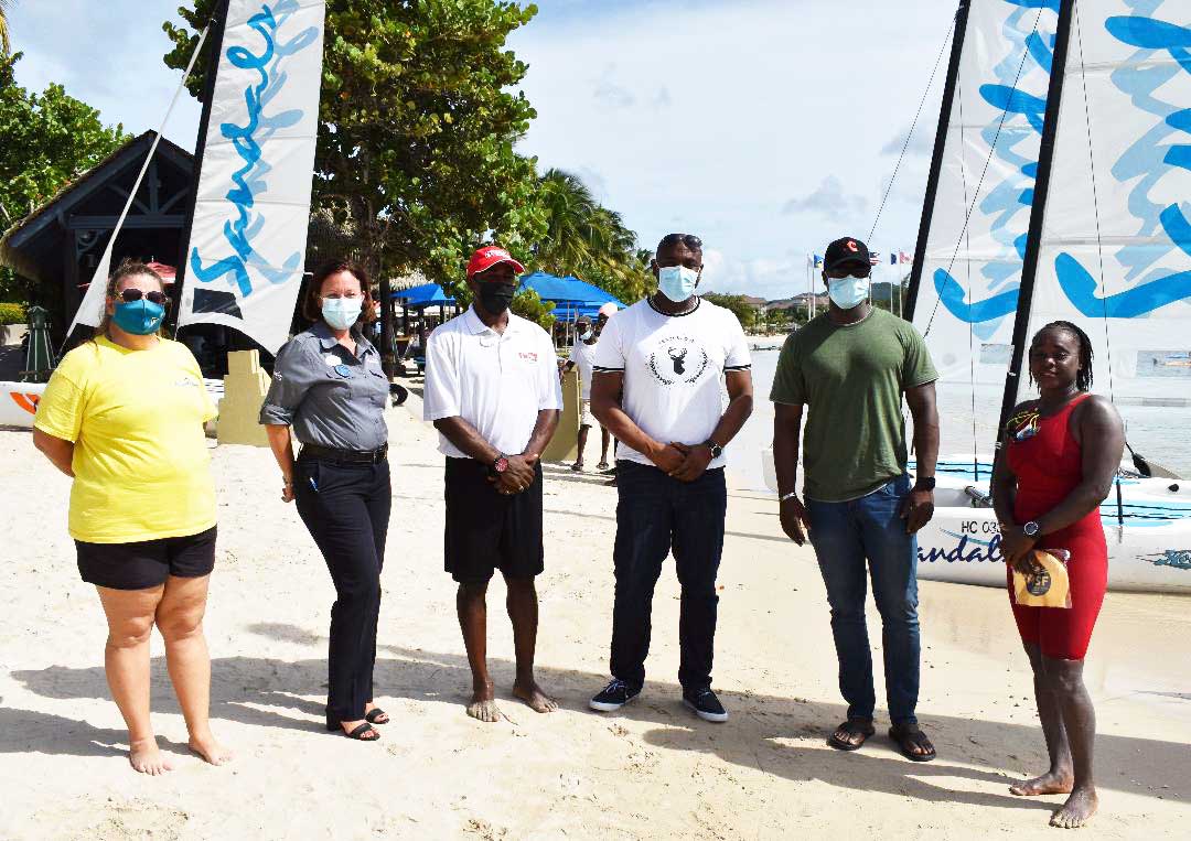 (L-R) Sue Dyson, Sandals Grande representatives, Minister’s Shawn Edward and Kenson Casimir and swimmer, Vanessa Eugene (Photo: Anthony De Beauville) 