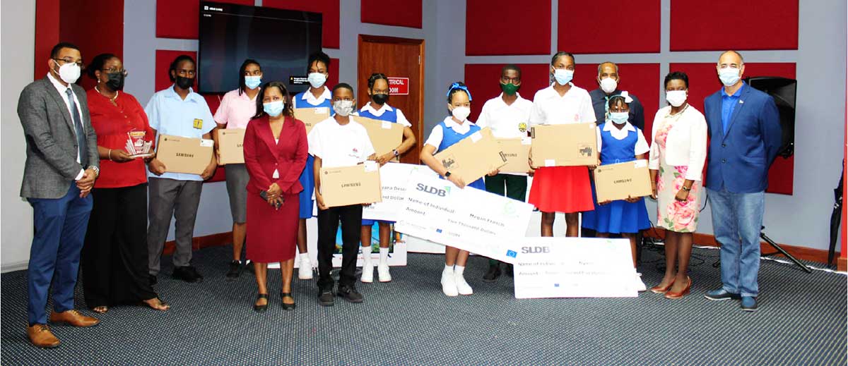Competition winners flanked by Bank Executives and Officials of the Ministry of Education.