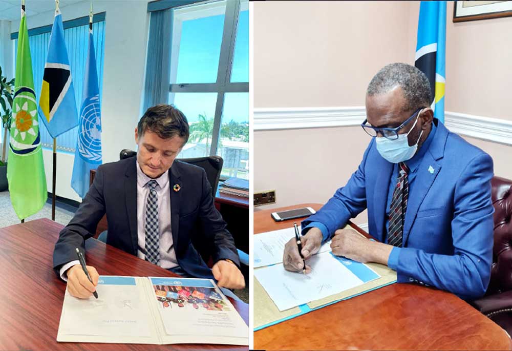 [L-R] Mr. Didier Trebucq & Prime Minister, Hon. Philip J. Pierre signing documents