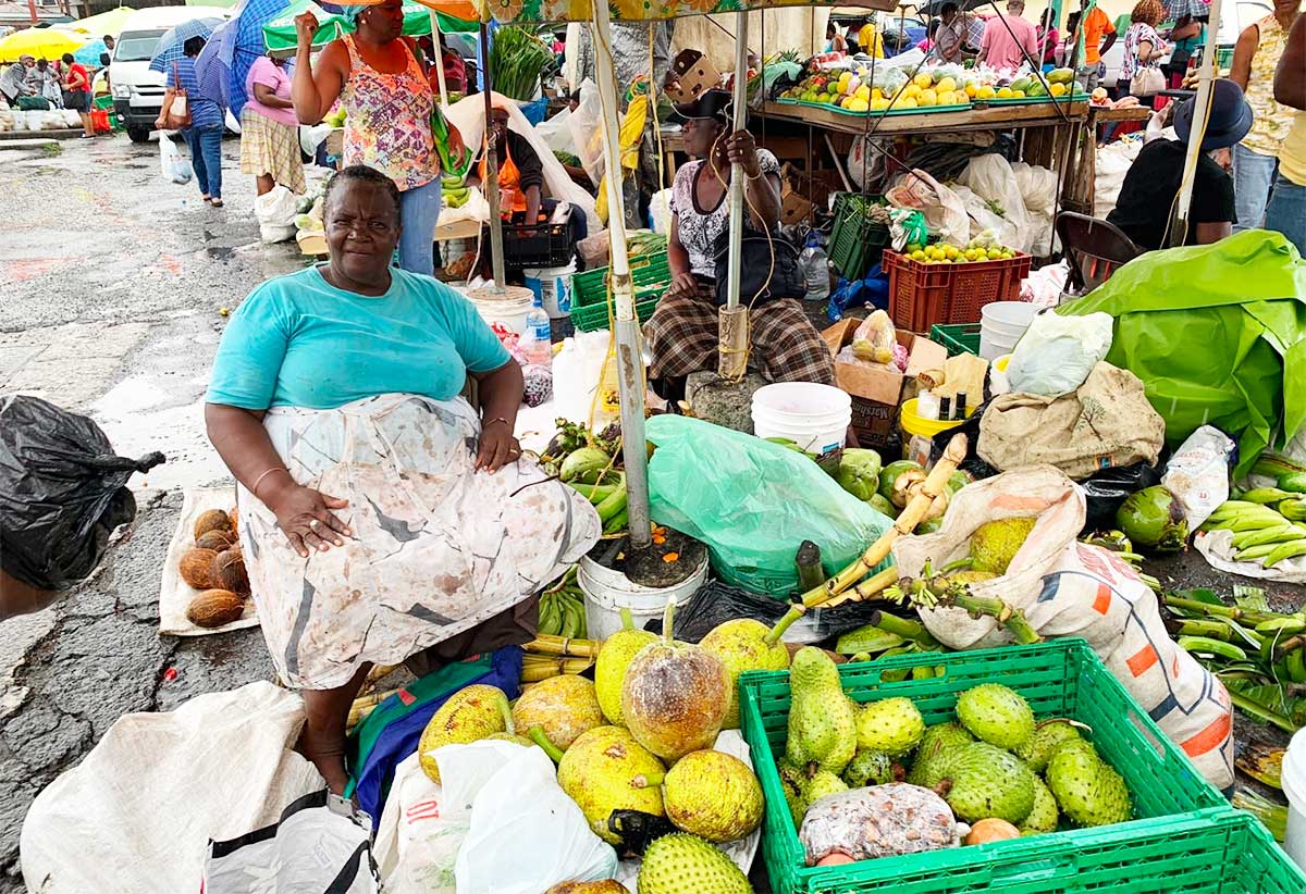 A seated produce vendor