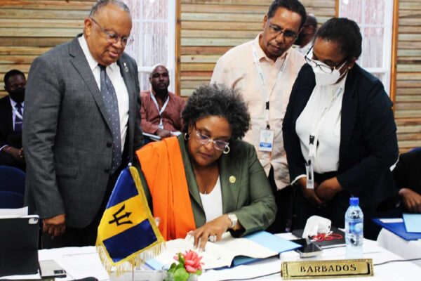 Barbados' PM Mia Mottley signing the Enhanced Cooperation Protocol.