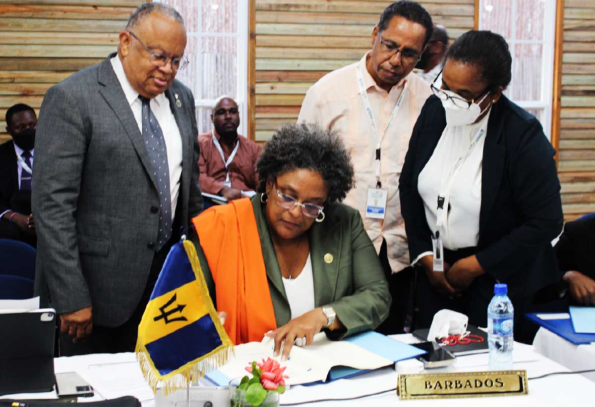 Barbados' PM Mia Mottley signing the Enhanced Cooperation Protocol.