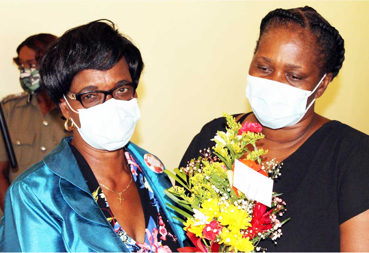 Minister Albert-Poyotte (l) with deceased officer's mother, Perpetua Dieudonne.