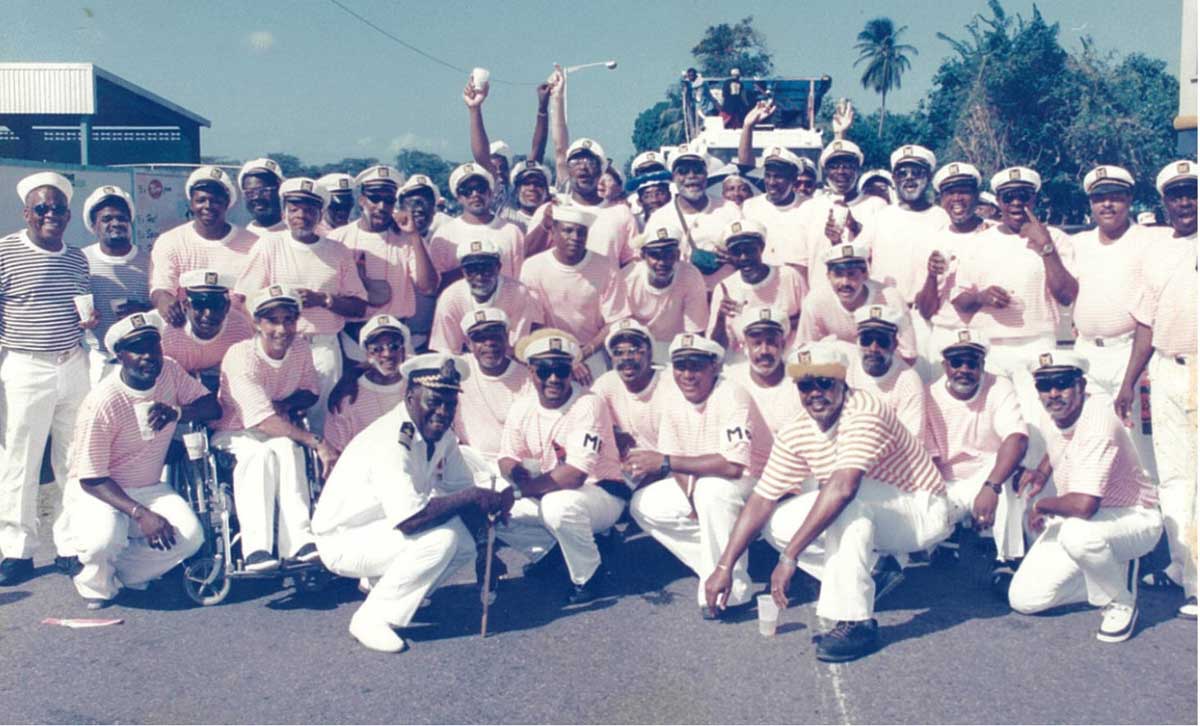 Zex the reveler (front row) and members of the Cozy Guzzlers Carnival Band.