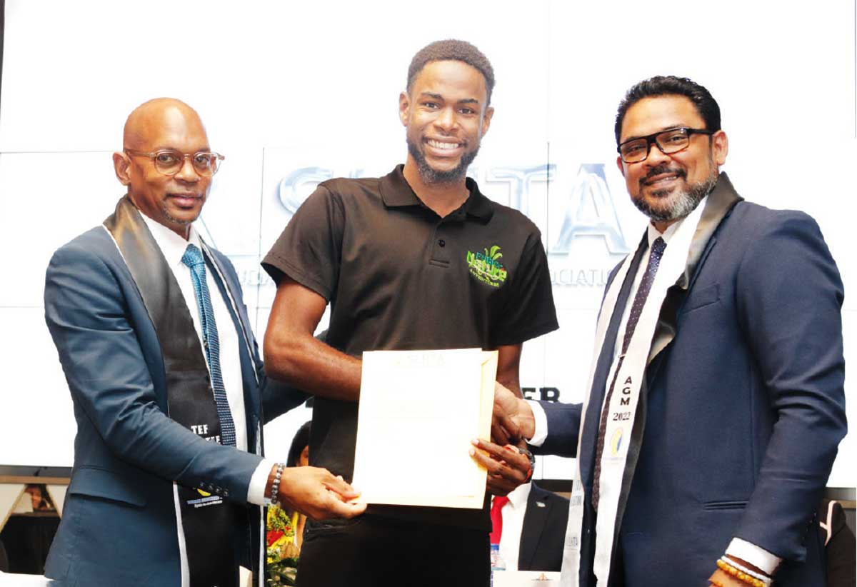 Mathurin (centre) accepting his complimentary membership letter from SLHTA’s CEO Senitor Noorani Azeez (R) and President Paul Collymore (L)