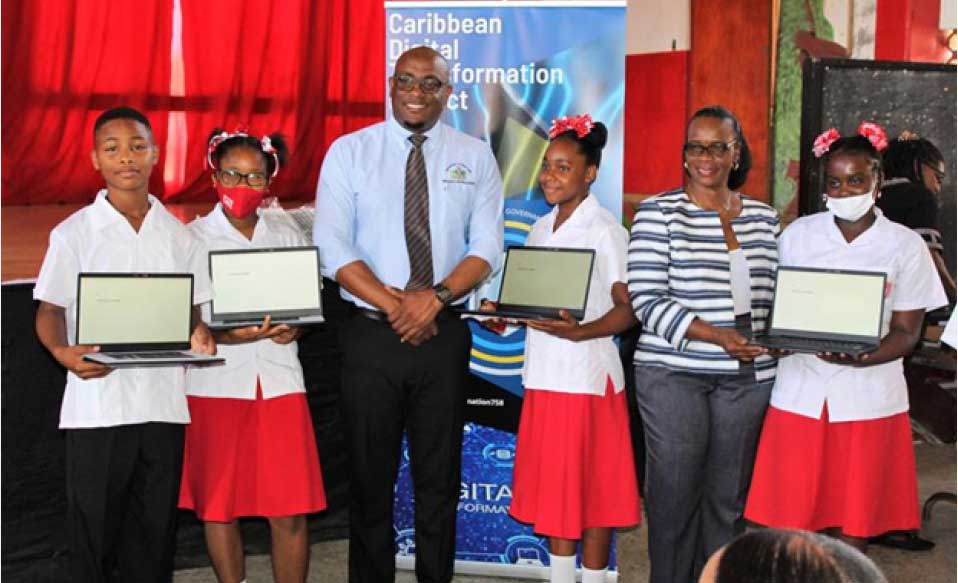 Minister of Education Sean Edward and Gender Affairs Minister Dr. Virginia Albert-Poyotte presents laptops to CCSS students.