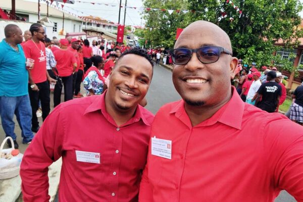 Micoud North MP Jeremiah Norbert and MP for Dennery North Shawn Edward share a light moment outside the conference hall.