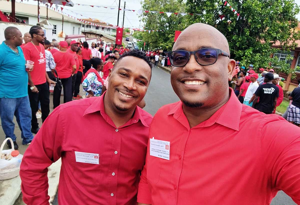 Micoud North MP Jeremiah Norbert and MP for Dennery North Shawn Edward share a light moment outside the conference hall.