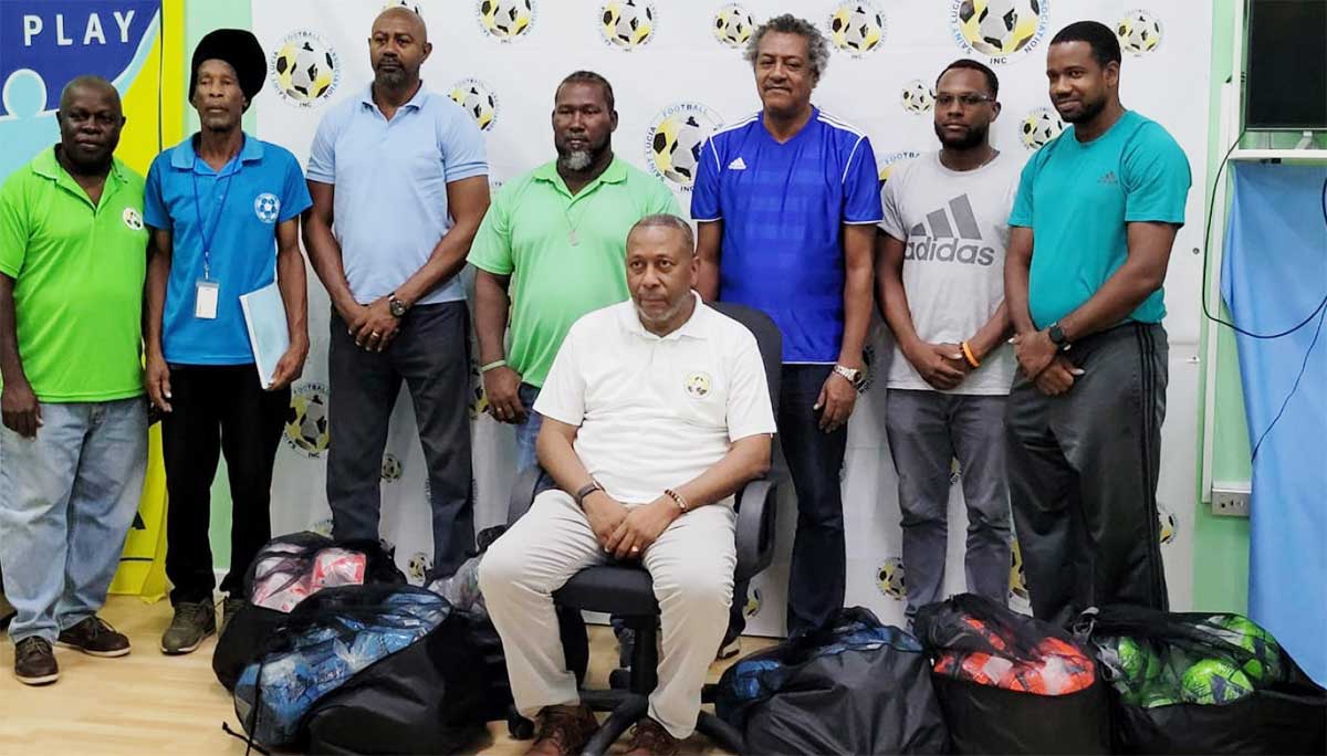 Coaches with SLFA Inc. President Lyndon Cooper (seated) and Program coordinator John Sealy (extreme left). 