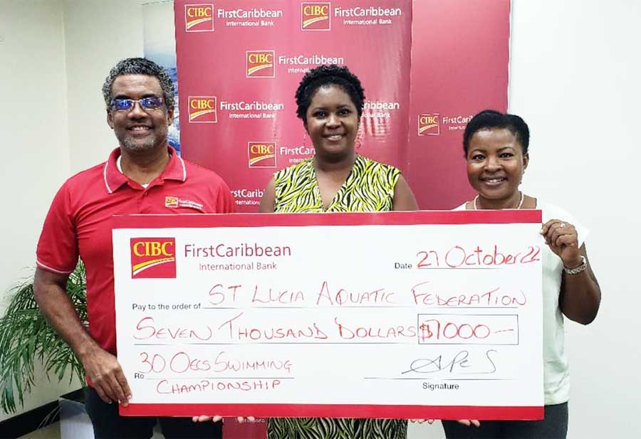 CIBC FCIB Country Manager at left presenting the cheque to representatives of the Saint Lucia Aquatic Federation. 