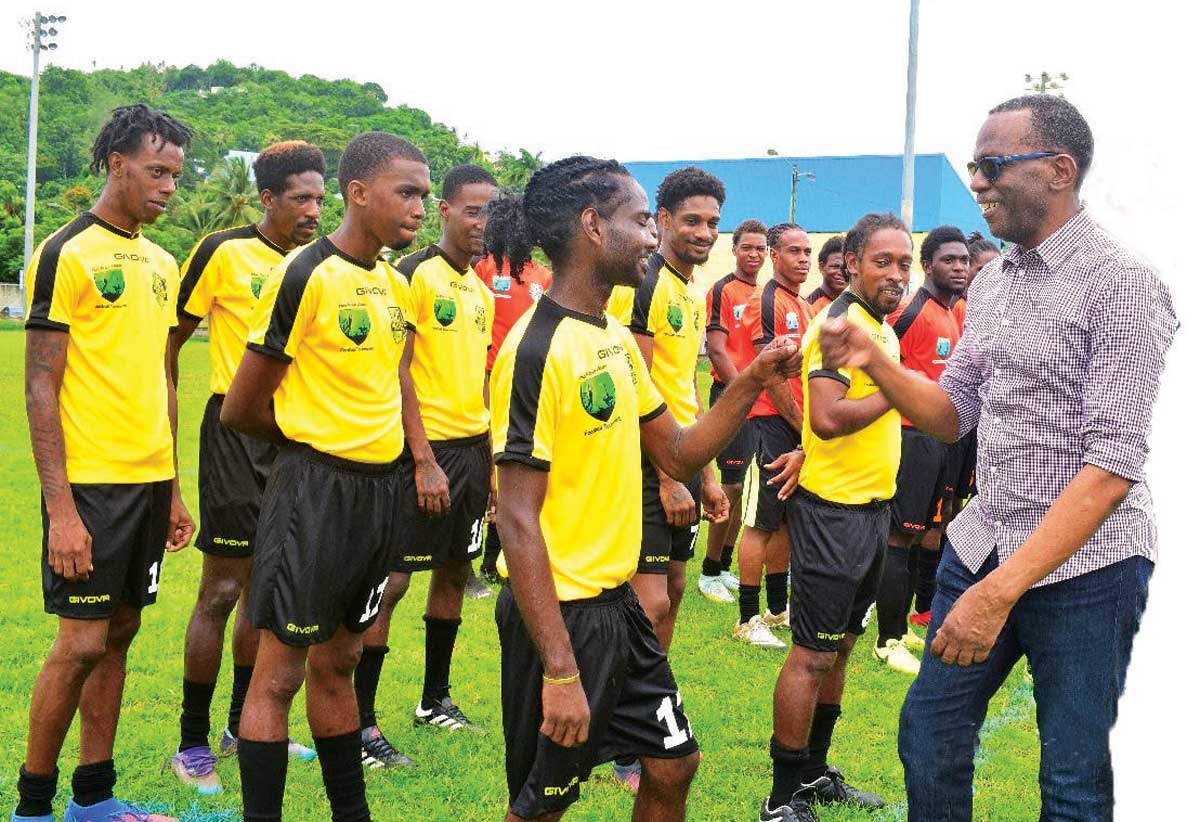 Teams under the Marchand League meeting PM Philip J Pierre at the commenement of the PJ Pierre Football competition.