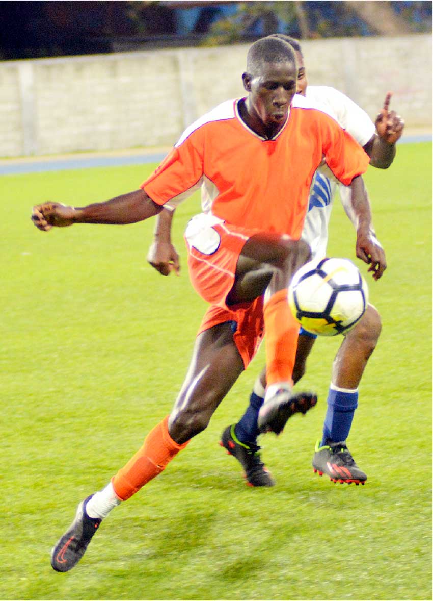 Laborie keeps possession of ball in a tight challenge. [Photo by Dave Pascal]
