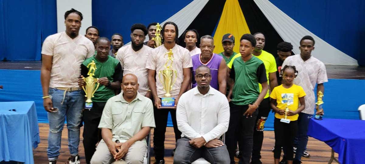 Champion team in GIFL Beach Football competition FA Young Boys with MP Kenson Casimir (right) and Mayor Egbert Lucien (left)