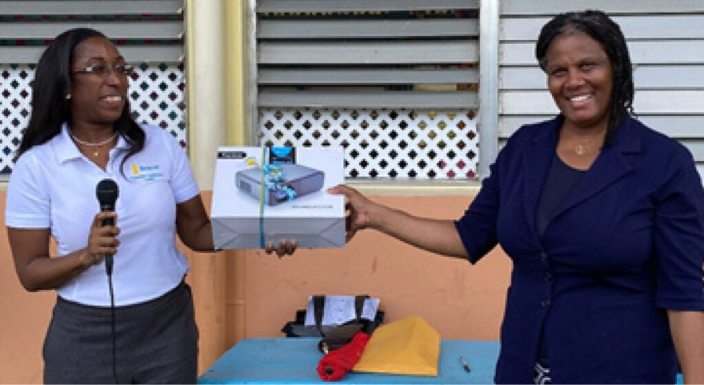 Assistant Branch Manager at Beacon St Lucia, Gilbertha Stoddard (left) handed over the equipment to Principal of the Grand Riviere Primary School, Mrs. Julietta Charles (right), in the presence of students.