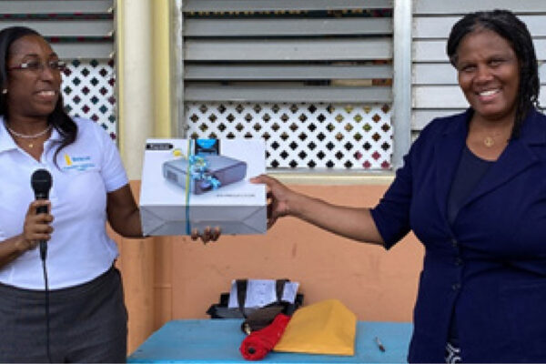 Assistant Branch Manager at Beacon St Lucia, Gilbertha Stoddard (left) handed over the equipment to Principal of the Grand Riviere Primary School, Mrs. Julietta Charles (right), in the presence of students.