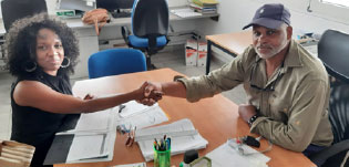Saint Lucia businesswoman and entrepreneur Stacey Mc Vane and business counterpart Hervé Étilé of Martinique shake hands following the signing of agreement.