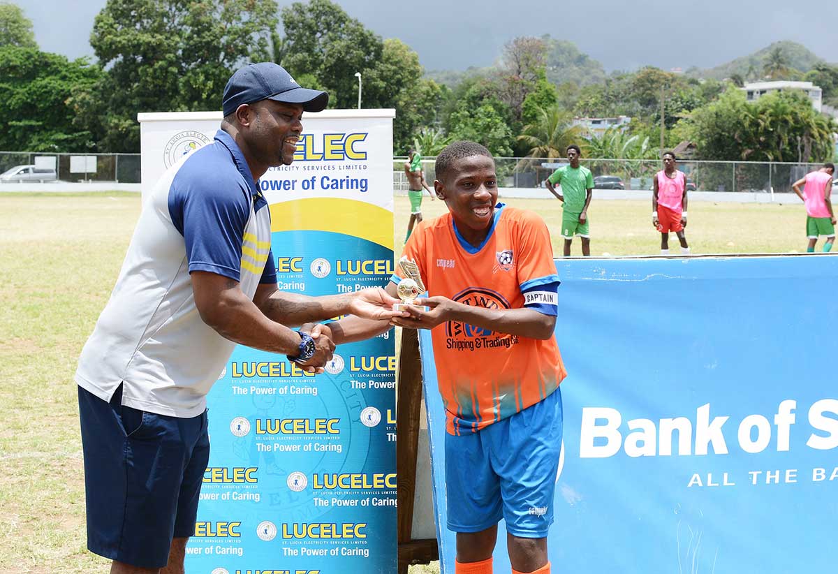 National head coach Stern John presents VSC captain Keon Morgan with MVP award.