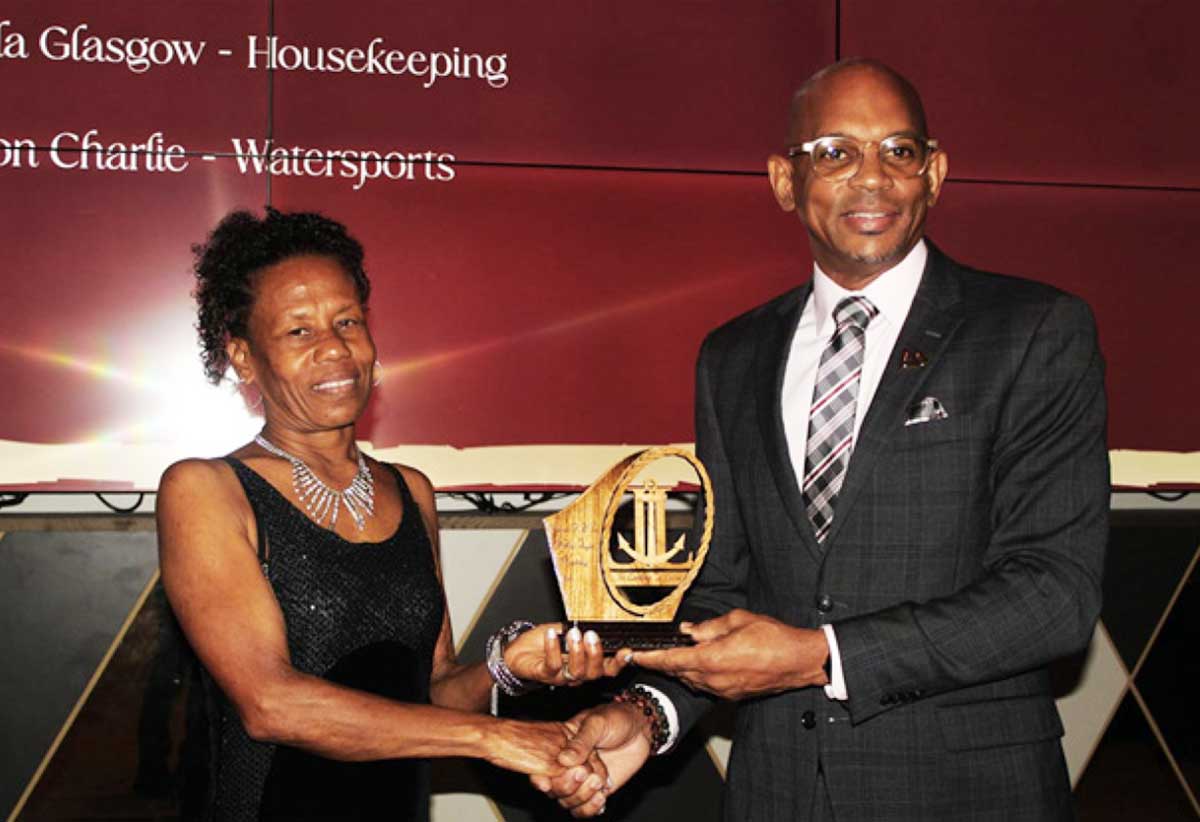 Paul Collymore, CEO of The Landings Resort & Spa, right, presents an award to one of the winners at the staff awards ceremony.