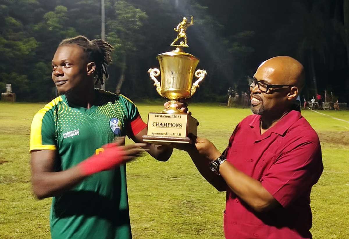 BAYS FC captain collects the Championship Trophy from Castries South East MP Joachim Henry. 