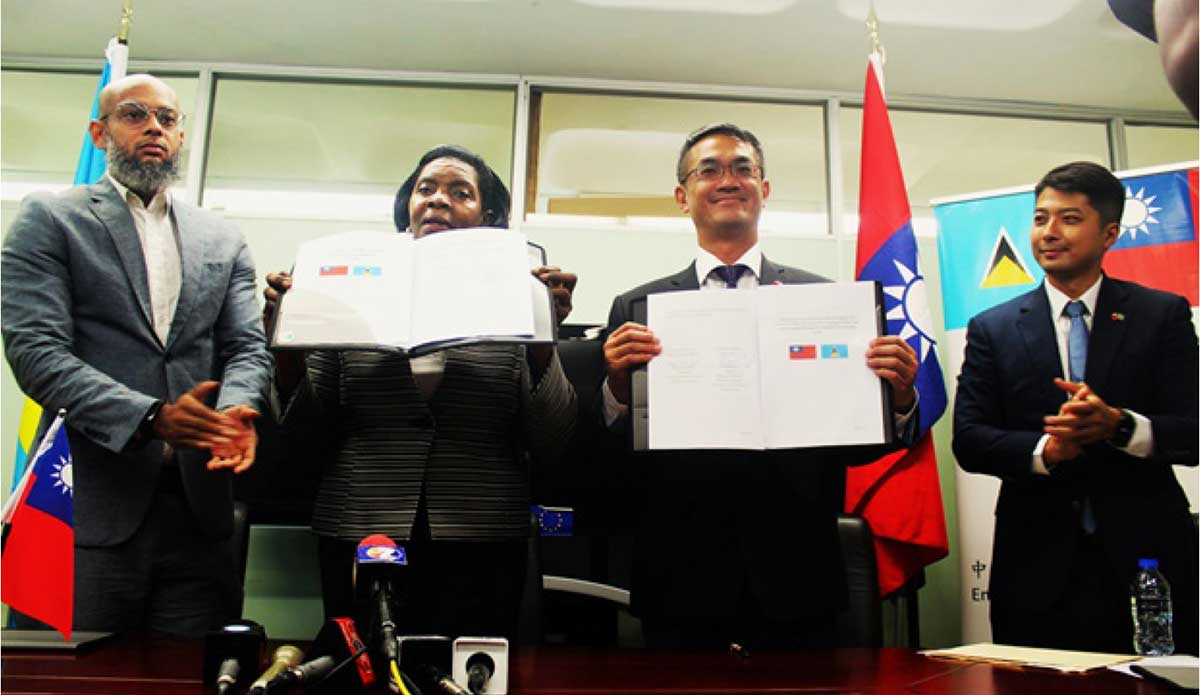 His Excellency Peter Chia-yen Chen, Taiwan’s Ambassador to Saint Lucia, and Hon. Emma Hippolyte, Minister for Commerce, Manufacturing, Business Development, Cooperatives and Consumer Affairs, at the June 13, 2023, MoU signing ceremony in the Ministry of Commerce conference room. At far left is Mr. Dylan Norbert Inglis, Legal Officer, Ministry for Commerce, Manufacturing, Business Development, Cooperatives and Consumer Affairs, while at far right is Mr. Daniel Lee, Head of Taiwan Technical Mission (TTM) in Saint Lucia. 