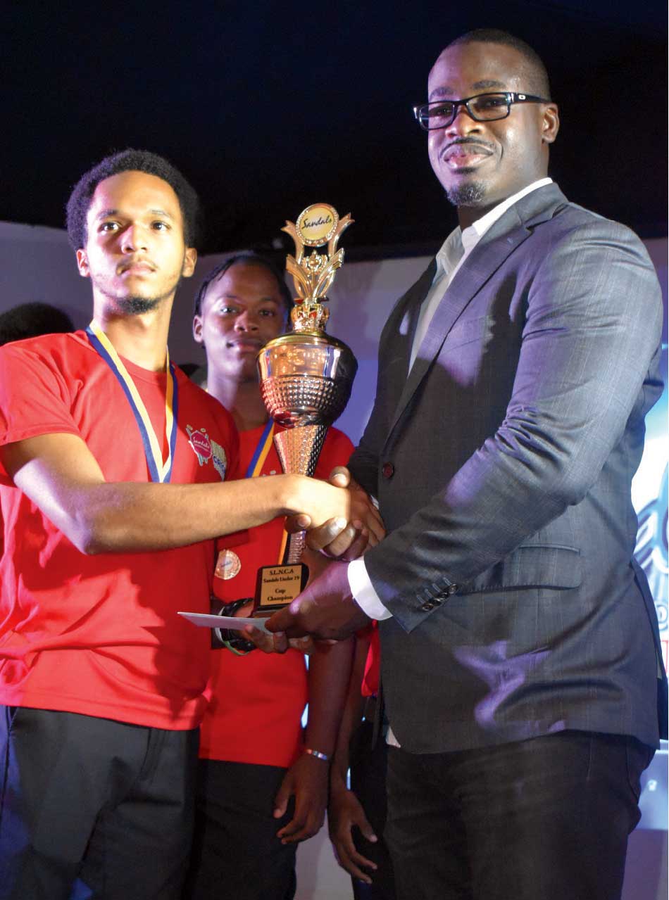 Sports Minister Kenson Casimir presents award to Top Batter of the tournament Khan Elcock