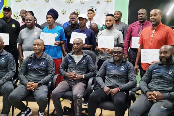 CONCACAF facilitators, SLFA officials and Certified Coaches display their certificates.