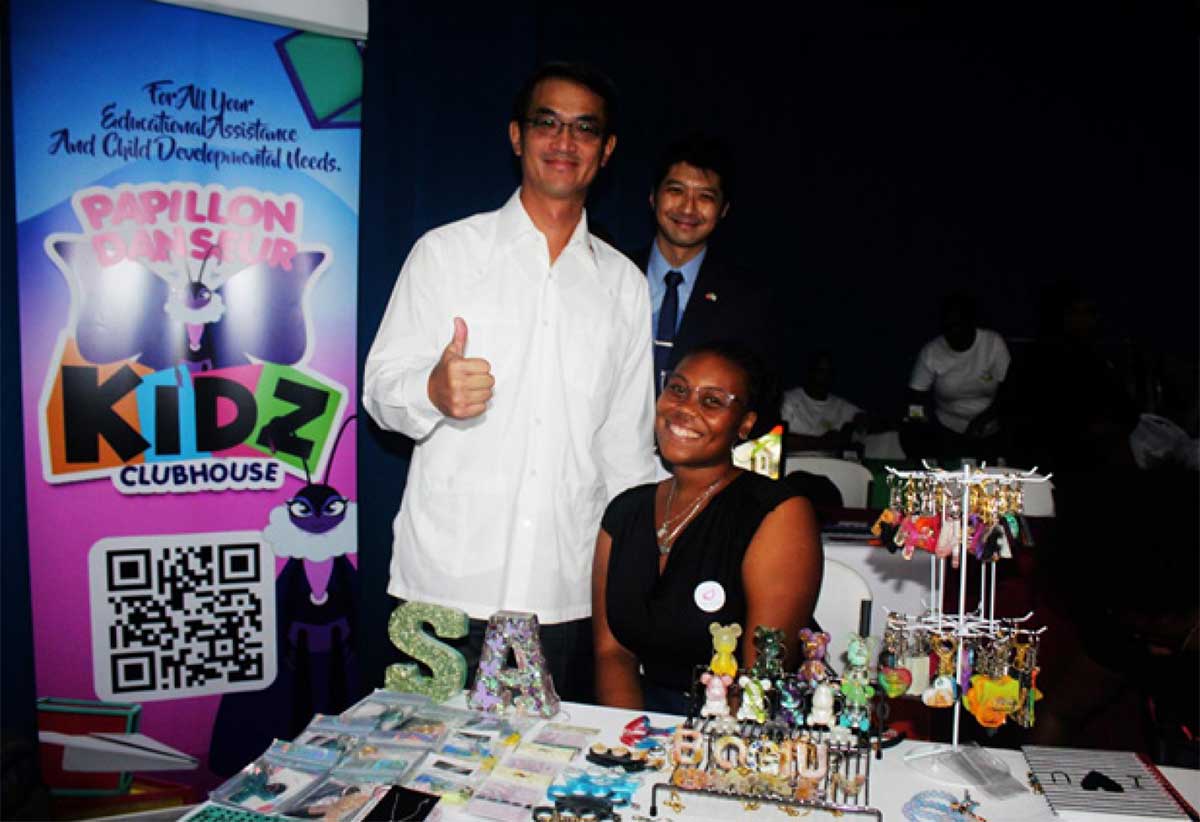 His Excellency Peter Chia-yen Chen, Taiwan’s Ambassador to Saint Lucia, far left, and Mr. Daniel Lee, Head of the Taiwan Technical Mission (TTM), centre, visit an entrepreneur’s booth at the Entrepreneur Showcase last Friday.