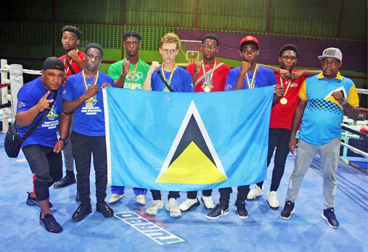 Coaches Yunior Quintero (far left) and Conrad Fredericks (far right) with the seven boxers who represented Saint Lucia at the August 18-20 tournament in Georgetown, Guyana