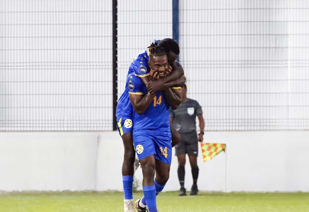 Prolific Saint Lucian striker Dom Poleon is mobbed by teammates after scoring against Sint Martin