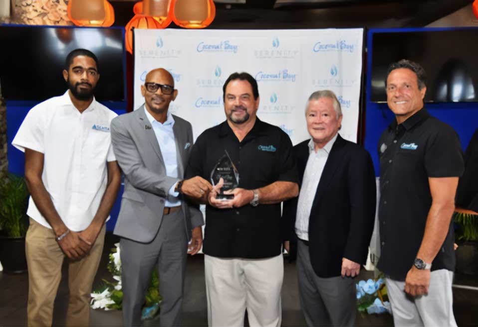 Mark Adams, President and CEO of Coconut Bay Beach Resort & Spa (centre) accepts an award of appreciation on behalf of the resort presented by Paul Collymore, President of the SLHTA. ( Also pictured): Joshua St.Aimee, SLHTA Communications Officer; Gary ‘Butch’ Hendrickson, Chairman of Coconut Bay Beach Resort & Spa; and Zachary Frangos, General Manager of Coconut Bay Beach Resort & Spa.