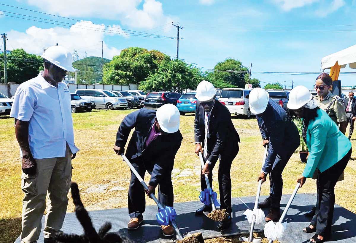 Officials turning the sod on the site set aside for the new police station