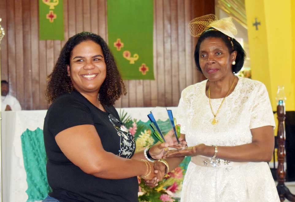 Heidi Hinkson (L), Manager, Ferrands Food Products, receiving an award from Commerce Minister Emma Hippolyte