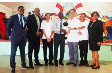 H.E. Peter Chia-Yen Chen, Taiwan’s Ambassador to Saint Lucia, third from right, presents one of the educational robots to Mr. Neal Fontenelle, Principal of St. Mary’s College, fourth from right, at Thursday’s handover ceremony. Also pictured are Mr. Anthony Bousquet, Chairman of the Board of St. Mary’s College, far left, Hon. Shawn Edward, Minister for Education, Sustainable Development, Innovation, Science, Technology and Vocational Training, second from left, Hon. Dr. Pauline Antoine-Prospere, Parliamentary Secretary in the Ministry of Education, far right, and two students.