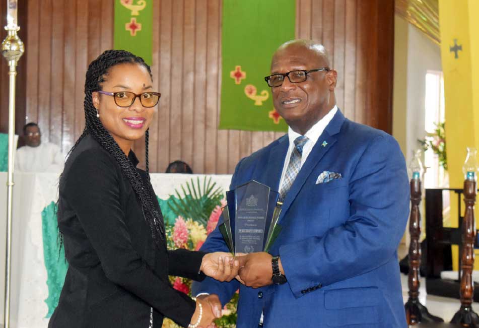 Award being handed over to Sarah Serieux-Lesmond, Operations Manager, M&C, by Infrastructure Minister Stephenson King