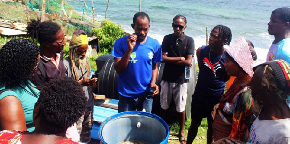 Thaddeus Constantine, Chief Agri-Enterprise Development Officer in the Ministry of Agriculture, (centre), explaining to workshop participants how the fermentation process works.